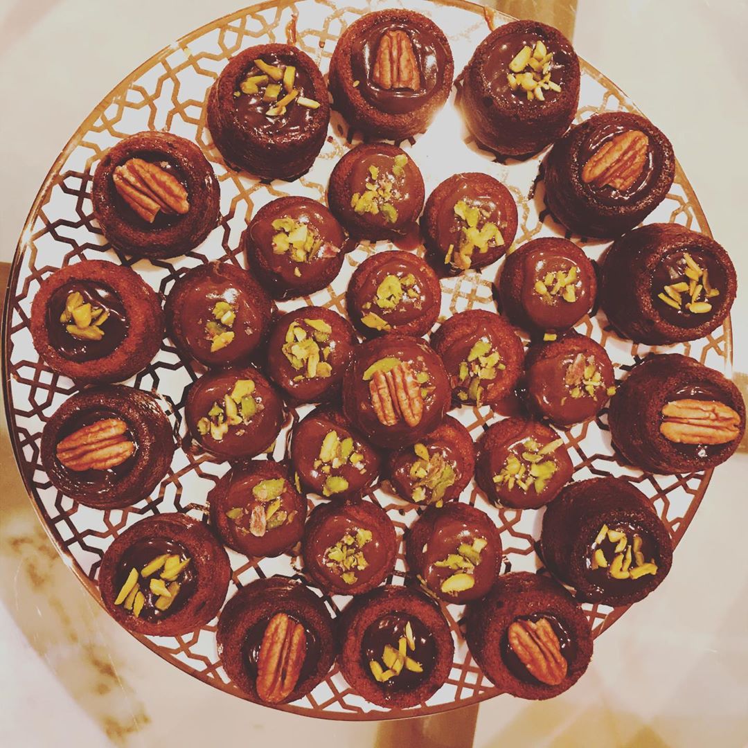 Mini Date Cake filled w/ nuts, topped w/ toffee sauce , & Decorated with pecans and pistac