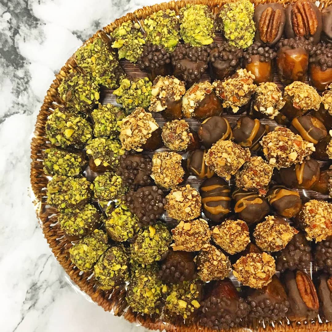 Stuffed dates covered with chocolate and nuts