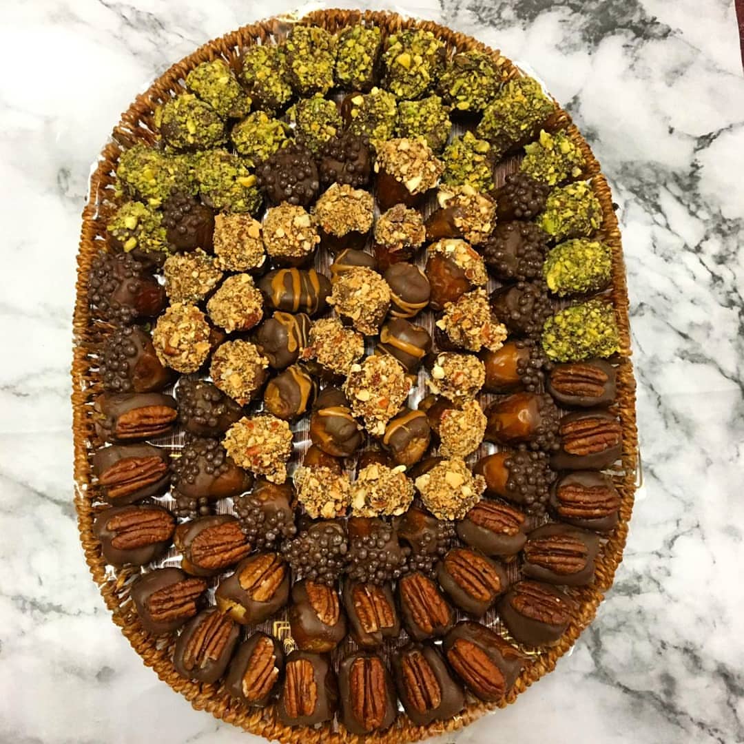 Stuffed dates covered with chocolate and nuts