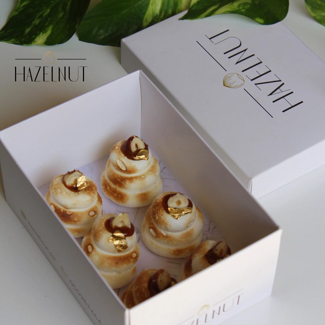 {1} Meringues Stuffed with dates sauce decorated with hazelnut Meringues Stuffed with date