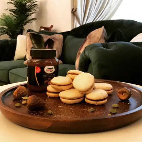 قبلت التحدي و دهنت التمر على ال ماكارون بالهيل و التمر #ادهن_التمر ماكارون بالتمر ٧١ جرام لون مطحون ١١٧ جرام سكر بودره بياض بيضتين ١/٤ كوب سكر ناعم ٠.٥ جرام هيل مطحون معجون التمر من قوودي Date and cardamom macaroon 71 g of Finely ground almonds 117 g powdered sugar 2 egg whites 1/4 caster sugar 0.5 g ground cardamom Goody date spread ننخل اللوز و السكر البودره ، نخفق البيض مع السكر الين يصير عندي ميرانج و نضيف الهيل و اللوز و السكر البودره و نخلطهم بهداوه الين ما يمتزجو نضع الخليط في صينيه على شكل دوائر و نتركها تنشف ١٥-٢٠ دقيقه و نخبزها في فرن على حراره ٣٥٠ لمده ١٣ دقيقه بعد ما تبرد نحشيها بالتمر Sift the almonds and powdered sugar and set aside whip the egg whites and sugar until stiffer peaks form fold in the cardamom and almond mixture and pipe into circles and dry it for 15-20 min , bake in a preheated oven at 350 for 13 min let to cool and fill it with the date spread